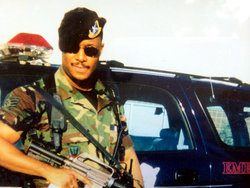 Clyburn in Fully geared Uniform Standing by a Car