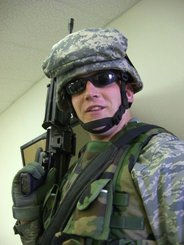 A Man Holding a Black Color Gun in a Uniform